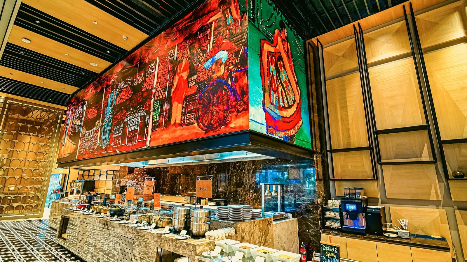 A colourful live station in the restaurant featuring artistic murals and a wide selection of food - Grand Madurai by GRT Hotels