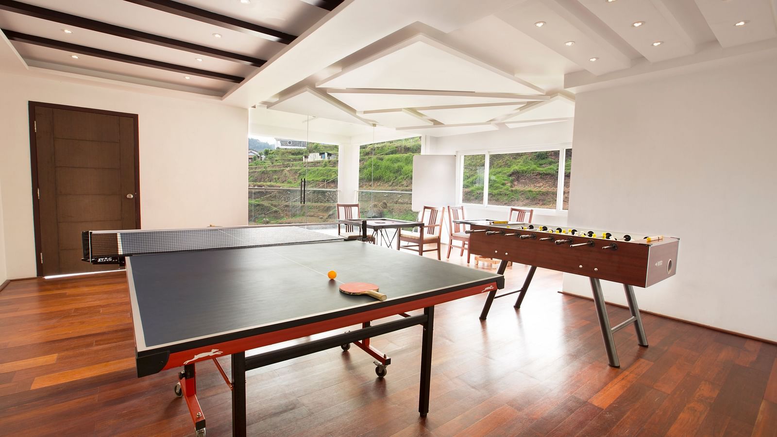 An image of the Activity Centre featuring different indoor games such as table tennis and foosball - GReaT Trails Kodaikanal By GRT Hotels
