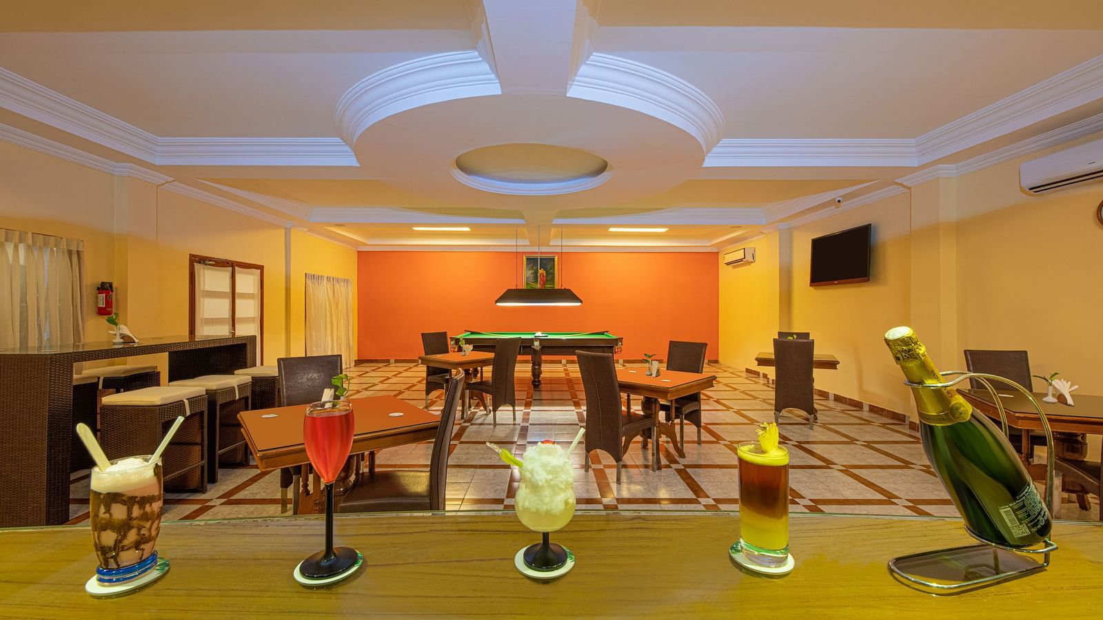 A shot of the dining space featuring different drinks at the table along with seating arrangement - Great Trails Yercaud by GRT Hotels    