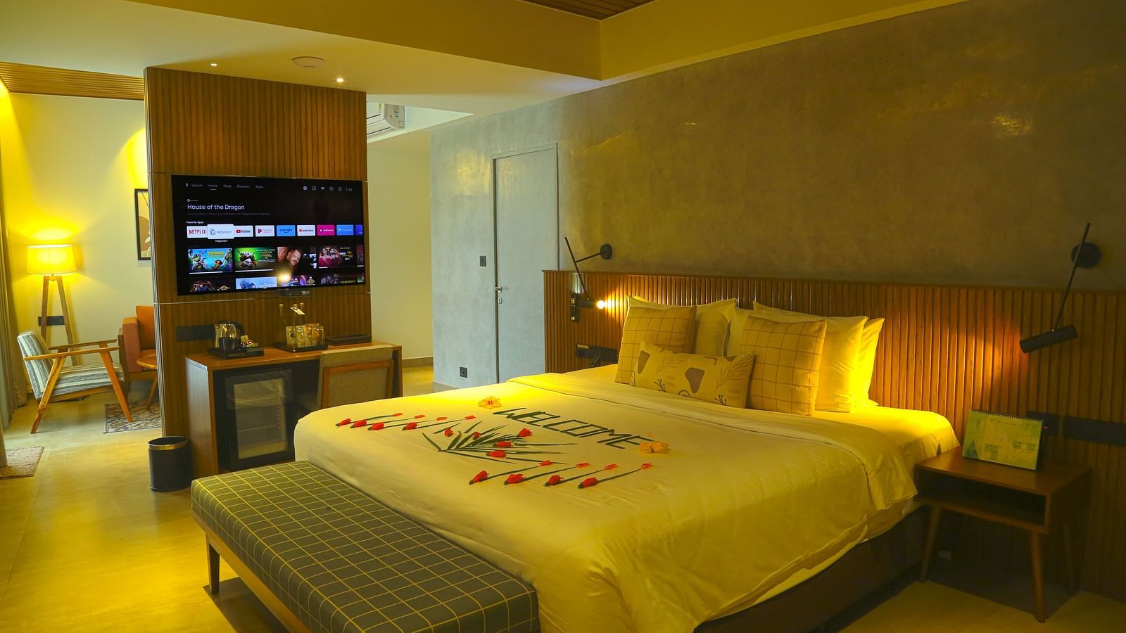An image of the pent house with a king size bed, couch, bed side table, flat screen TV, and separate living area - Great Trails Yercaud by GRT Hotels - Yercaud Family Rooms