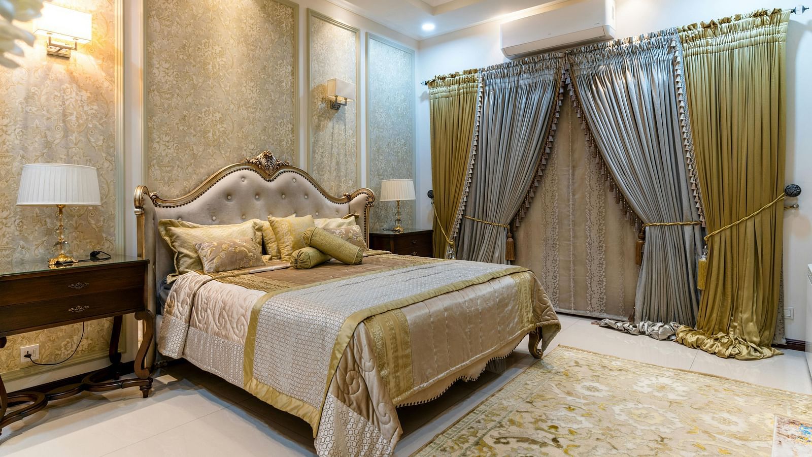 Luxurious bedroom with a plush bed, elegant curtains, and ambient lighting.