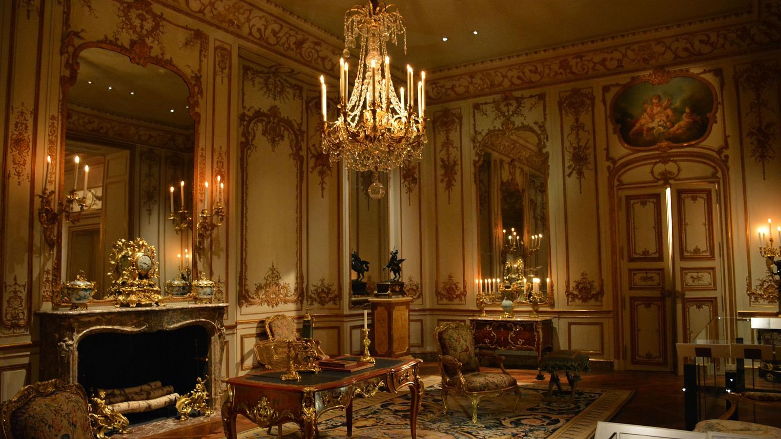 Luxurious palace room with ornate chandeliers and antique furniture.