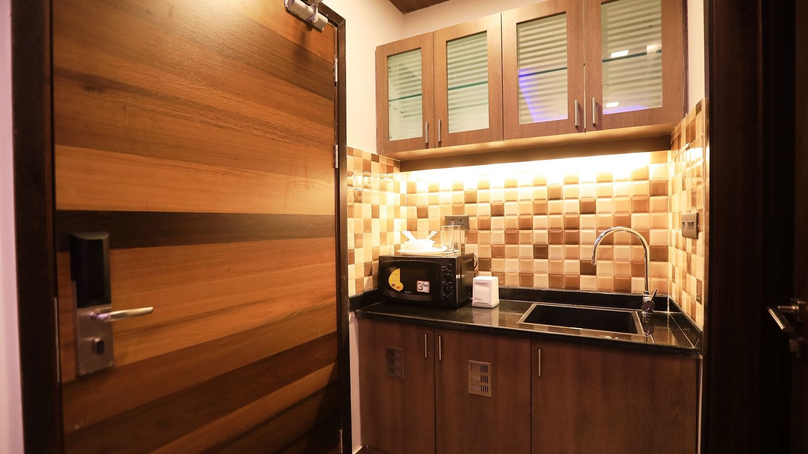 Image of a kitchen area with a sink and modern amenities at Hotel Altitude, Madikeri.