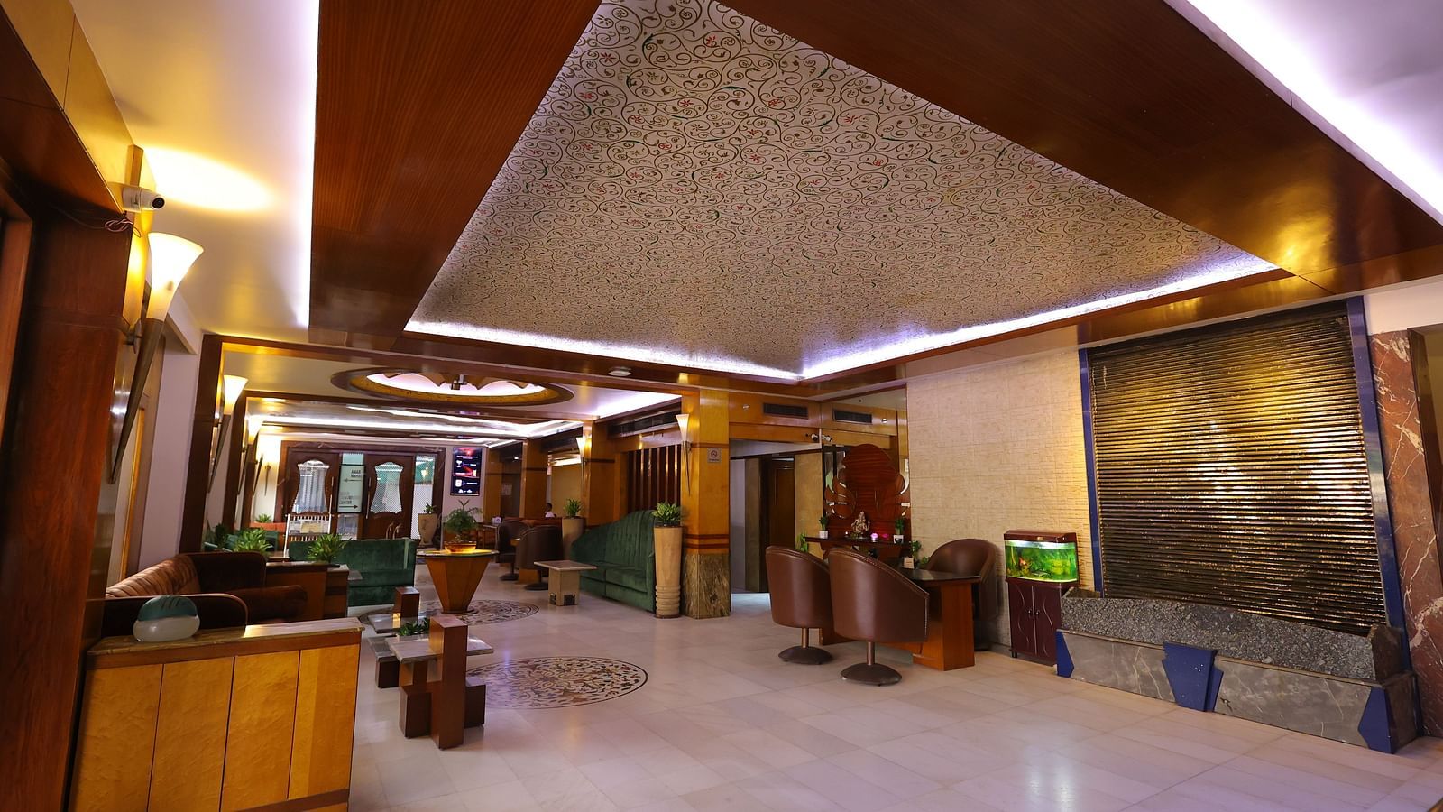 Side view image of the lobby of Hotel Amar with sofas and chair