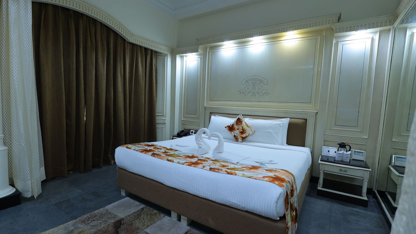 overview  image of a Suite at Amar Hotel with a bed, table, sofa and a window