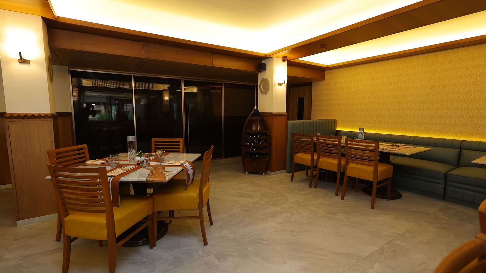 Overview image of Anam restaurant of Hotel Amar with chairs and tables arranged 
