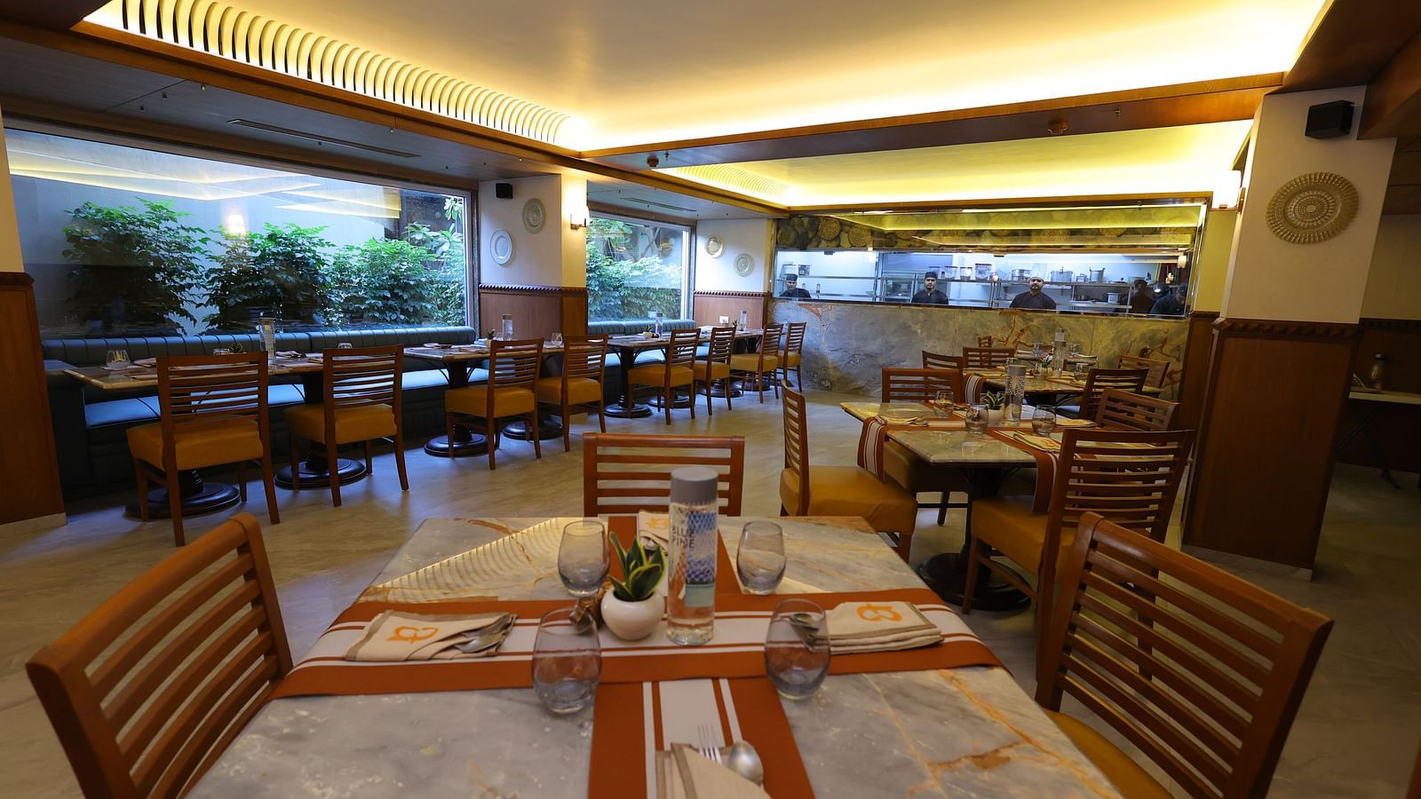 Close up image of Anam restaurant of Hotel Amar with chairs and tables arranged 