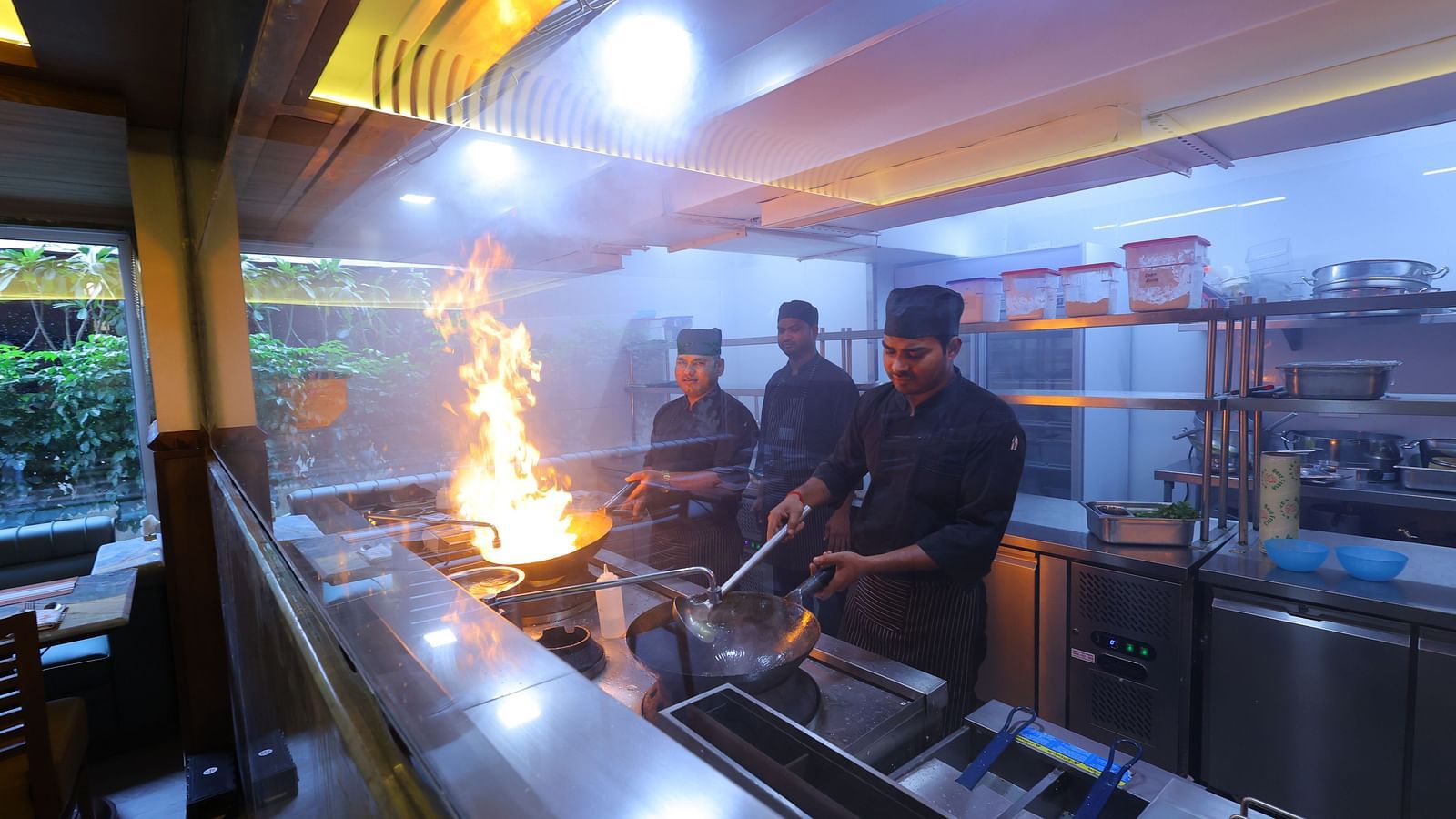Image of chefs cooking with high flame the anam restaurant of Hotel Amar
