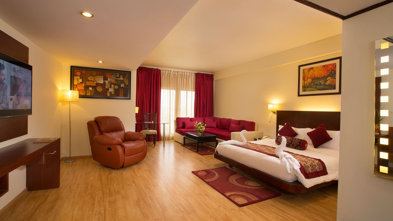 a view of Family Suite featuring a bed, a television and a recliner at Hotel Atithi - TGI Grand, Pondicherry