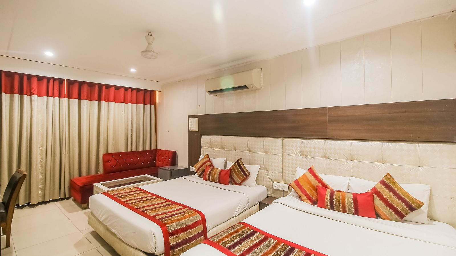 Family Room with two queen size beds and a seating area - Hotel Diamond Plaza, Chandigarh.