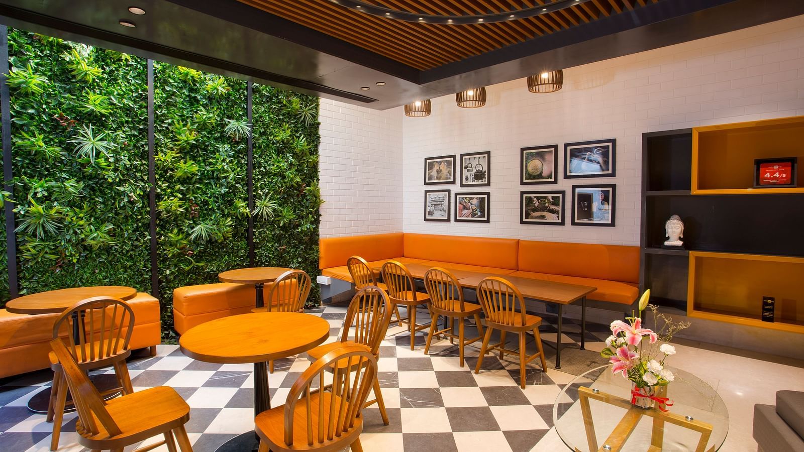 a room with large windows with views of trees and circular tables with chairs around them - Hotel Fountain Tree By TGI - JP Nagar, Bangalore