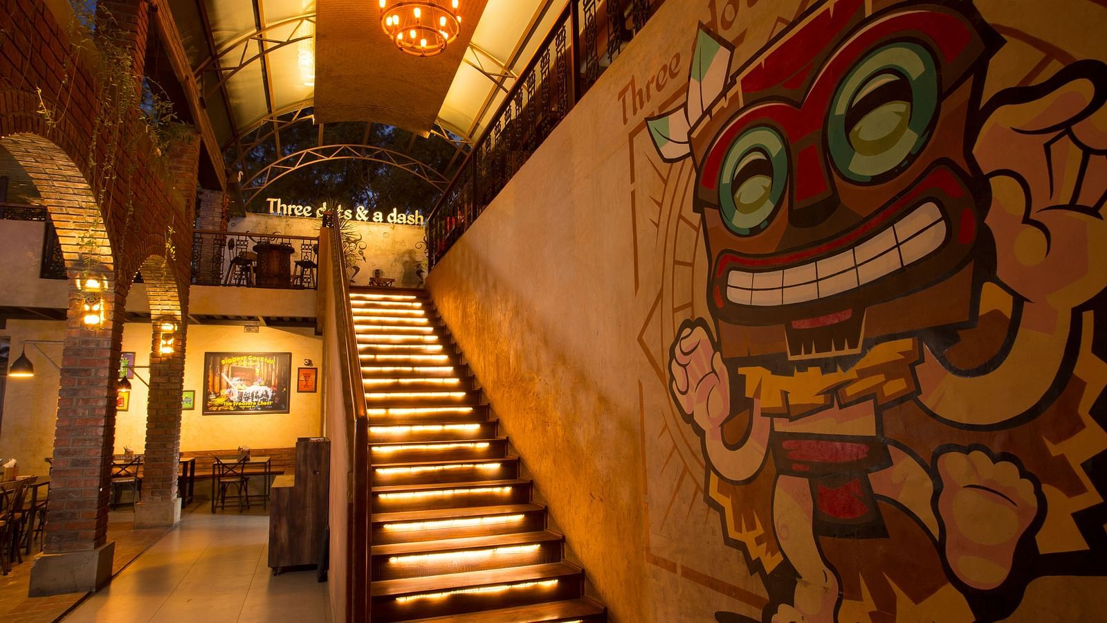 a staircase leading upstairs with graffiti on the wall beside the staircase - Hotel Fountain Tree By TGI - JP Nagar, Bangalore