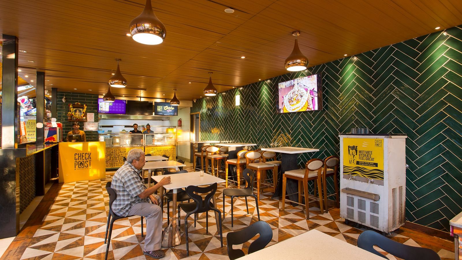 an indoor restaurant with clusters of tables and chairs across the room - Hotel Fountain Tree By TGI - JP Nagar, Bangalore