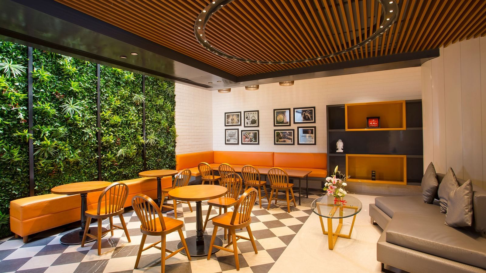 a room with large windows with views of trees and circular tables with chairs around them - Hotel Fountain Tree By TGI - JP Nagar, Bangalore