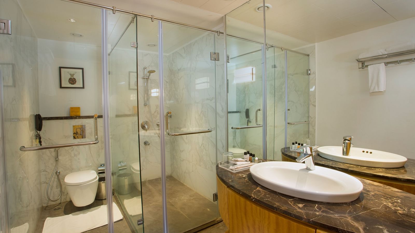 a washroom with a washbasin on the right and a western style toilet on the far end - Hotel Fountain Tree By TGI - JP Nagar, Bangalore