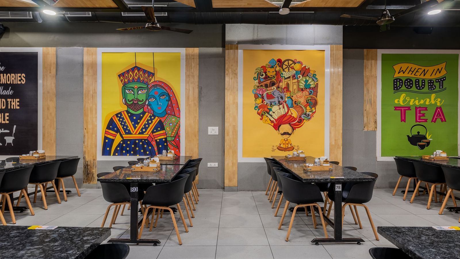 Pop-art style murals and twin seating near wall decor at Hotel Highway King, Bilaspur.