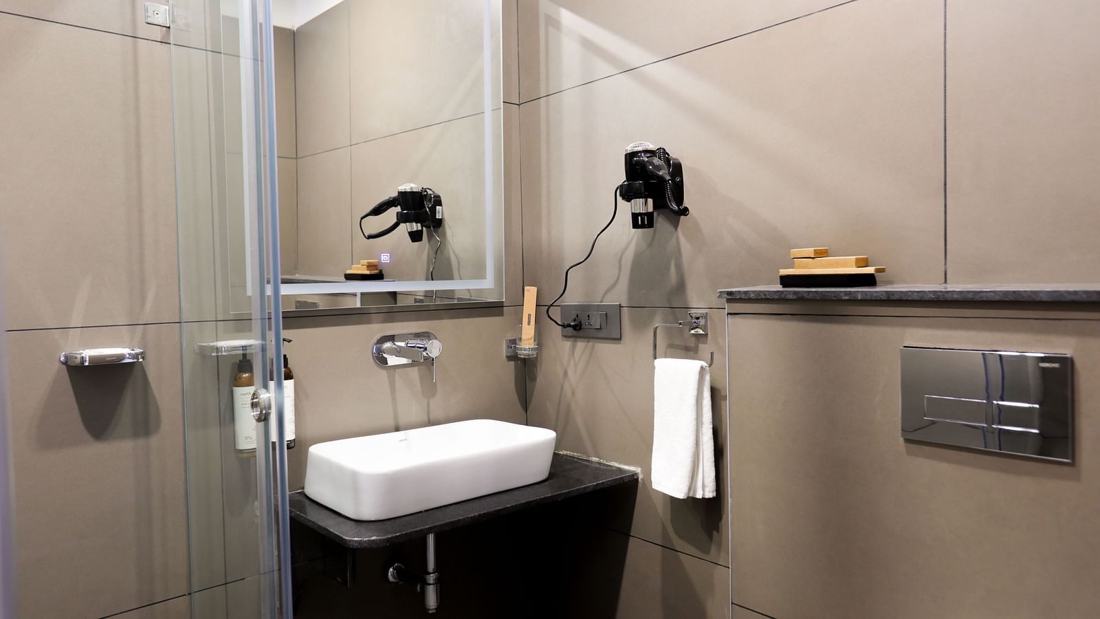 A bathroom at Hotel Kyzen HiTech City – Your Zenly Stay with sink, mirror, and hairdryer.