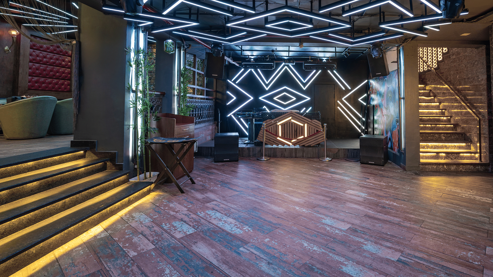 A dancing floor at Hotel Moti Palace featuring a DJ setup with colorful lighting, creating an energetic atmosphere for guests