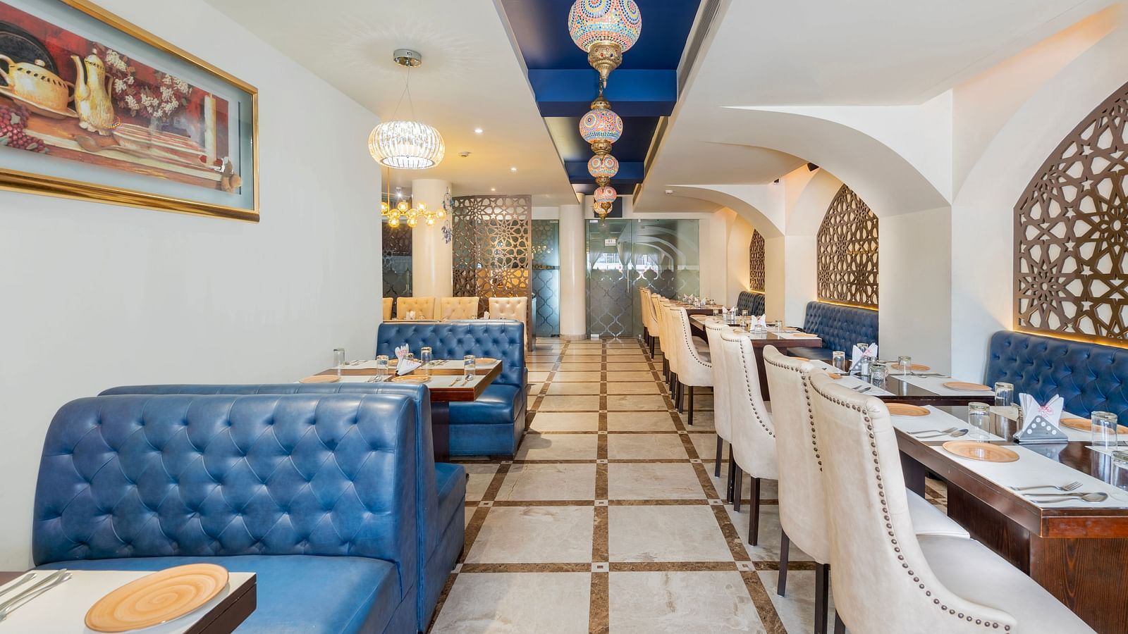 A n aisl view of the restaurant along with comfy sofa and table  Hotel Moti palace .