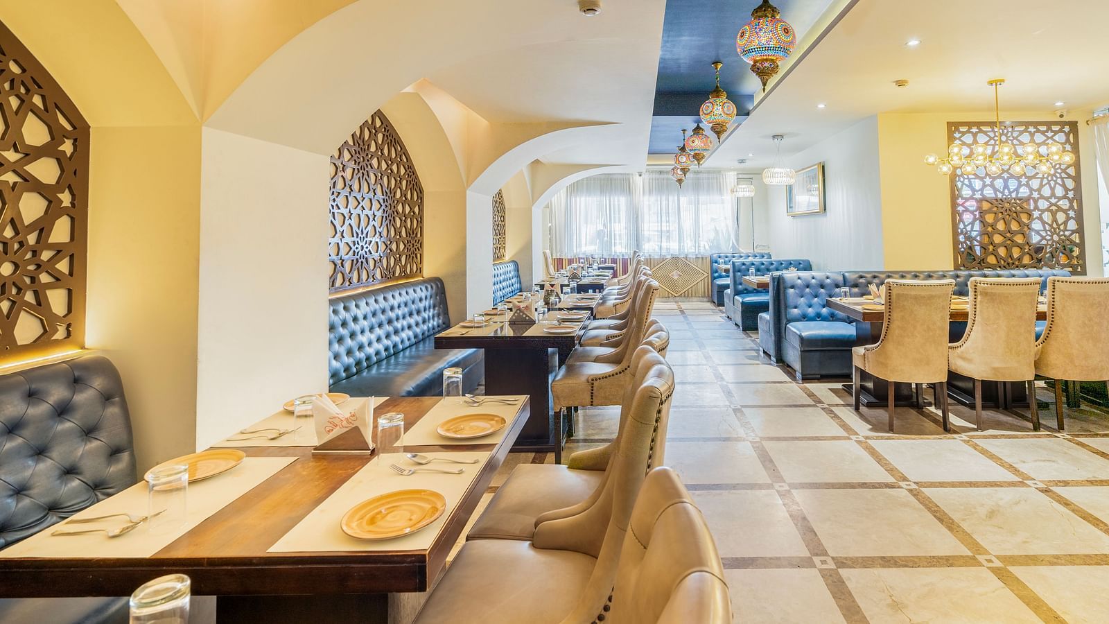 A wide angle view of the restraunt with royal look and comfy sofaHotel Moti palace .