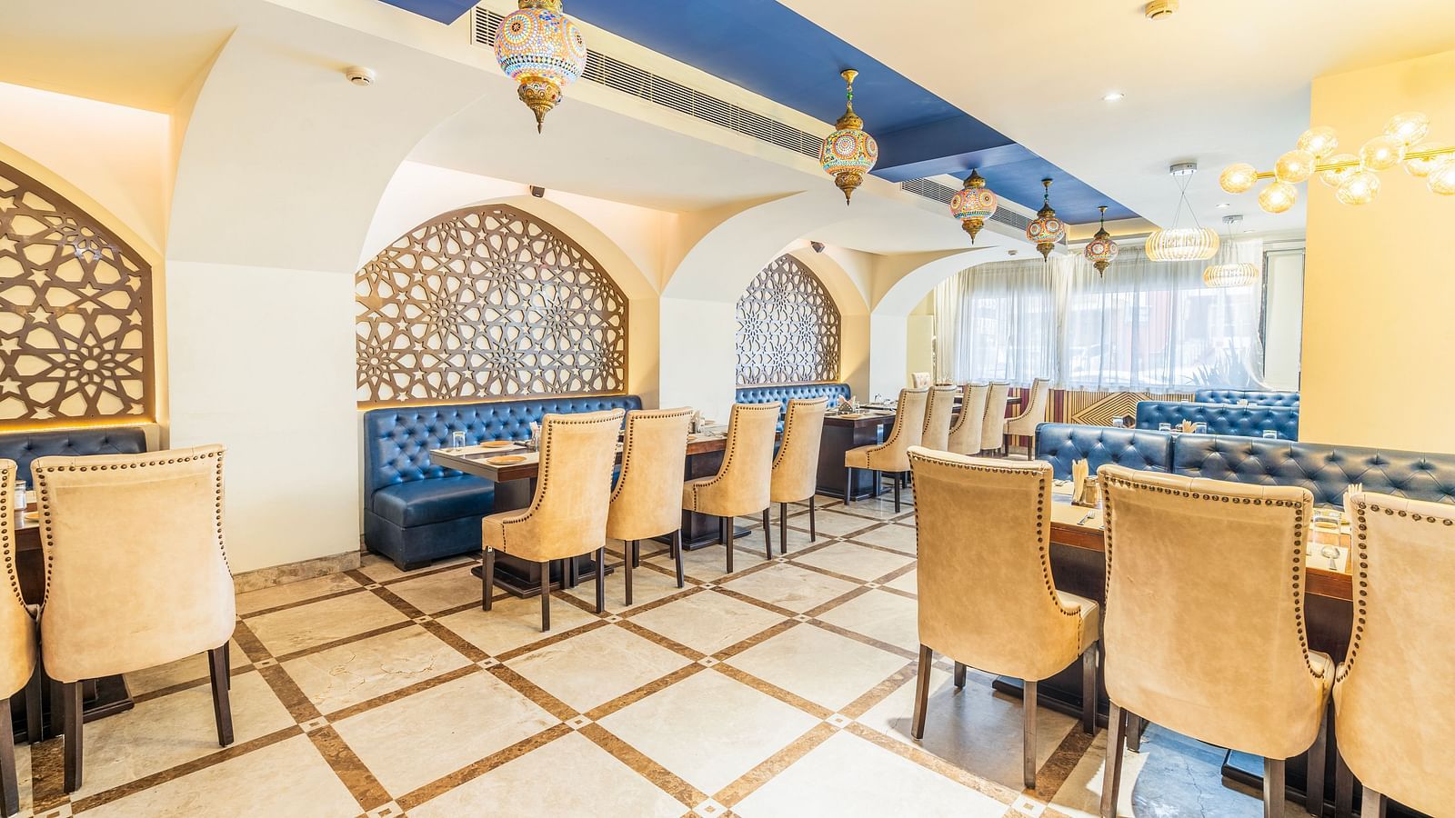 A side angle view of the restaurant and along with comfy chairs and tableHotel Moti palace .