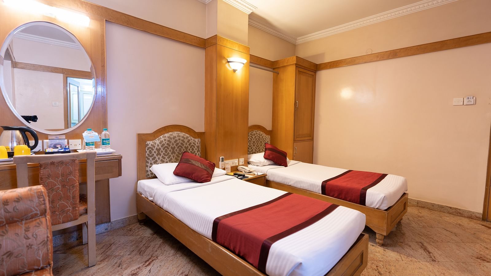 twin beds with a sofa on the side inside one of the rooms - Hotel Pai Comforts, JP Nagar
