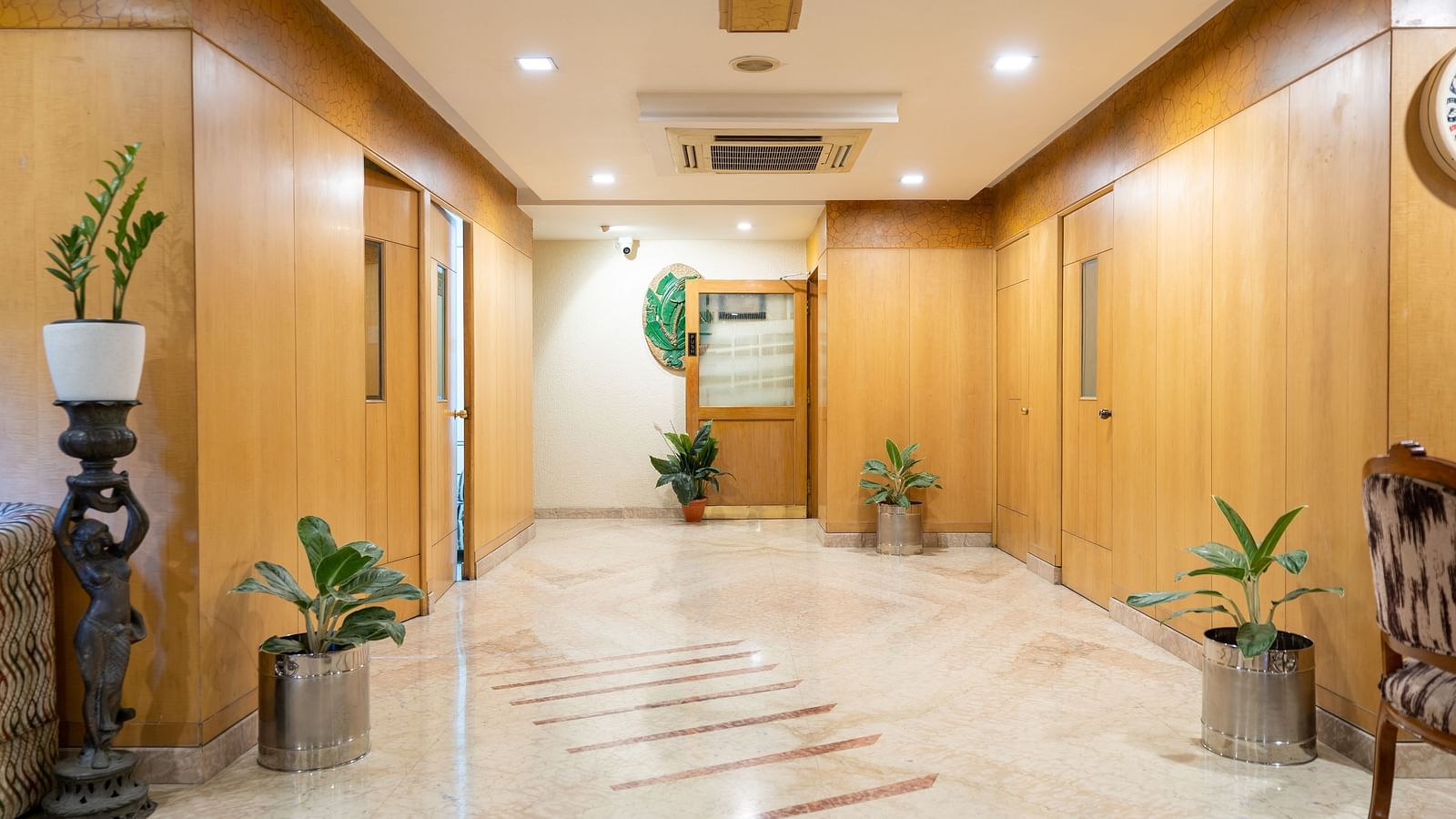 lobby view with potted plants kept on every corner - Hotel Pai Comforts, JP Nagar
