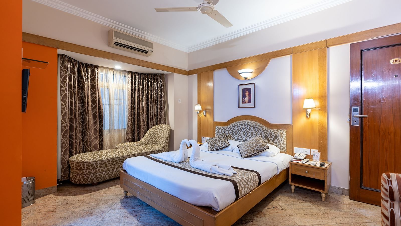 a double bed with a lamp above it inside one of the rooms - Hotel Pai Comforts, JP Nagar