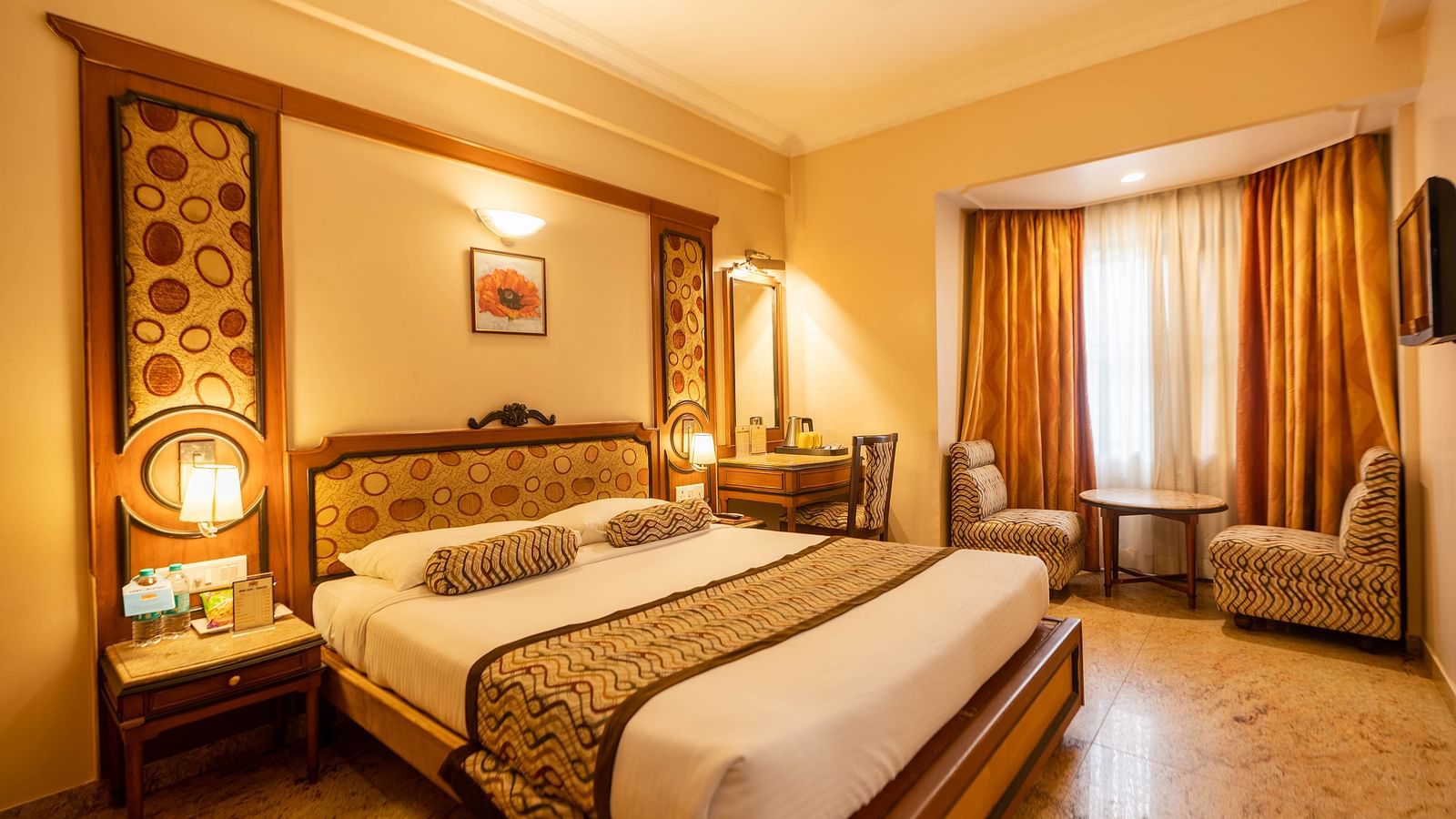 The Executive Room at Hotel Pai Viceroy Jayanagar featuring warm interiors and a queen sized bed amongst other amenities