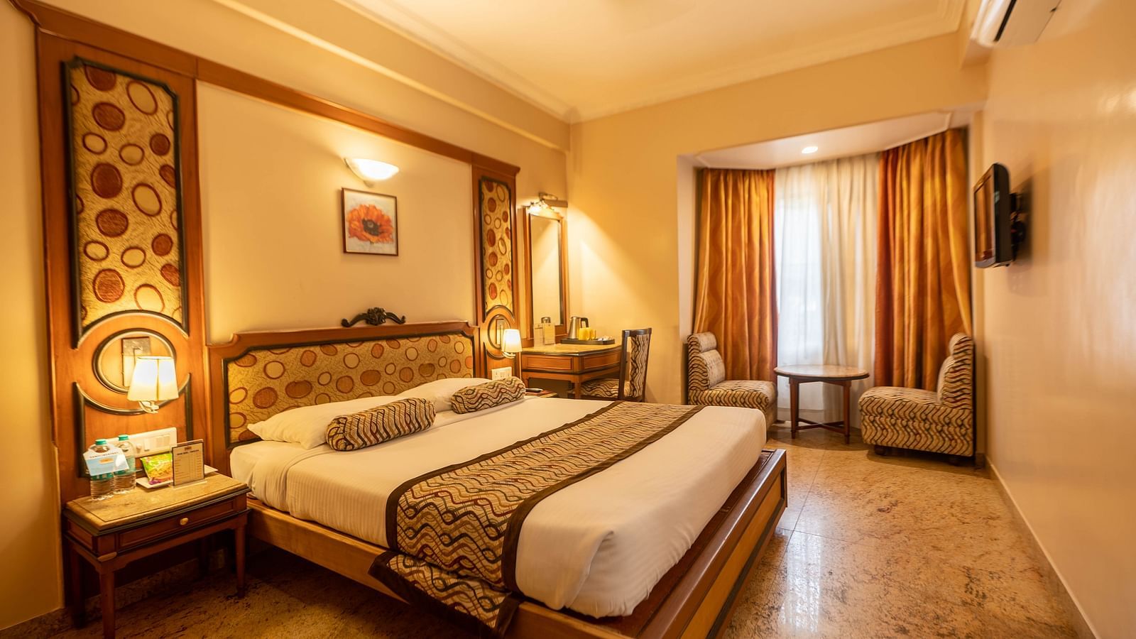 The Executive Room at Hotel Pai Viceroy Jayanagar featuring warm interiors and a queen sized bed amongst other amenities