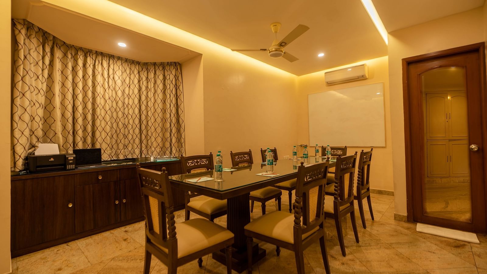 A meeting room at Hotel Pai Viceroy Jayanagar featuring seating for 8 persons, a white board and air-conditioning