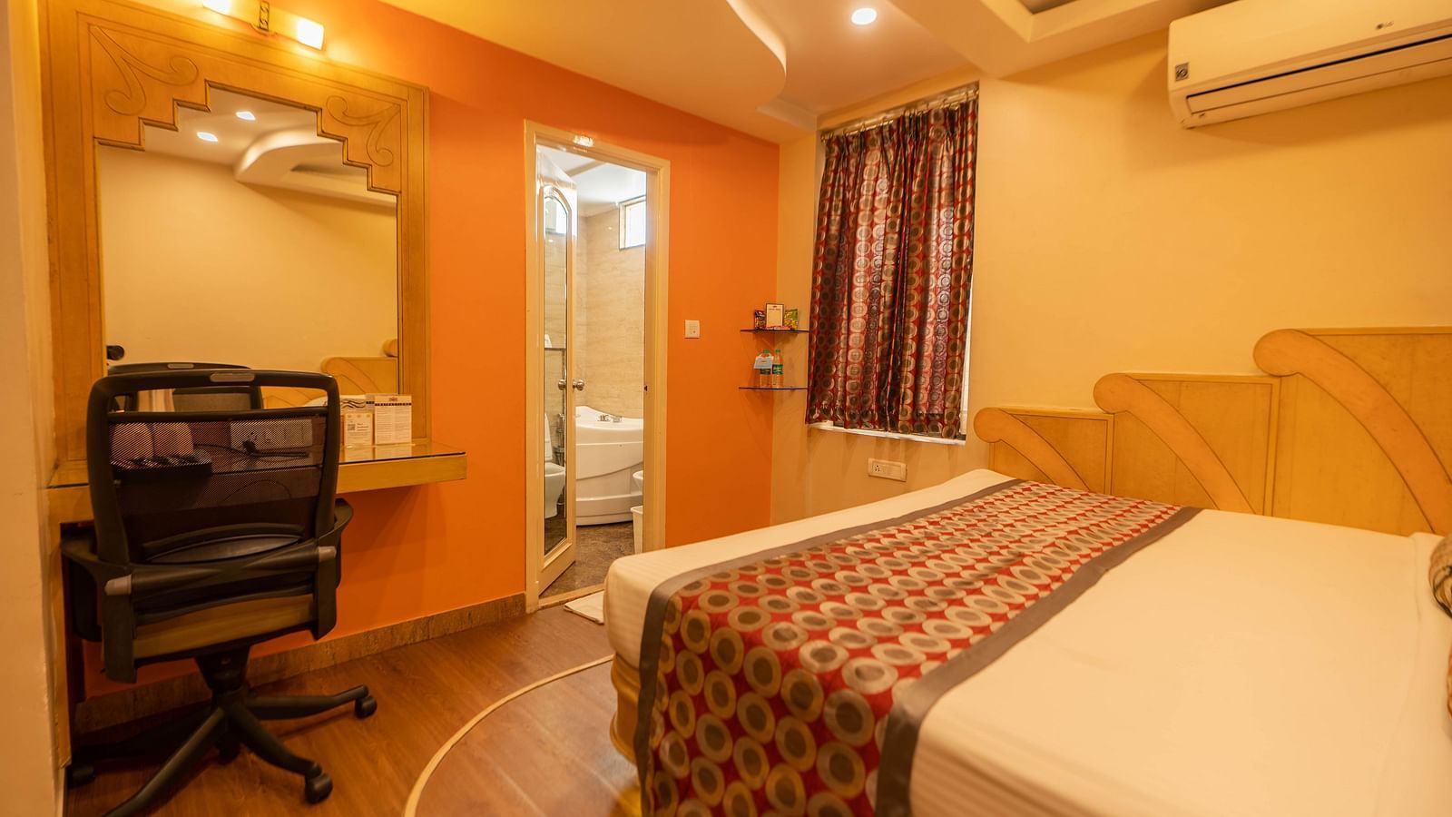 The Executive Room at Hotel Pai Viceroy Jayanagar featuring warm interiors and a queen sized bed amongst other amenities