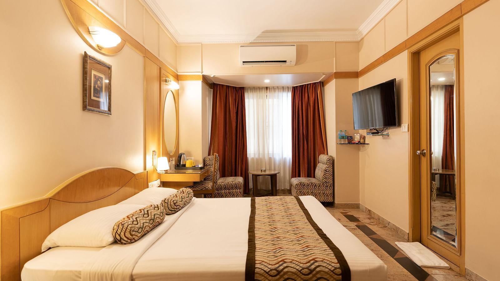 The Executive Room at Hotel Pai Viceroy Jayanagar featuring warm interiors, a coffee table and a television amongst other amenities