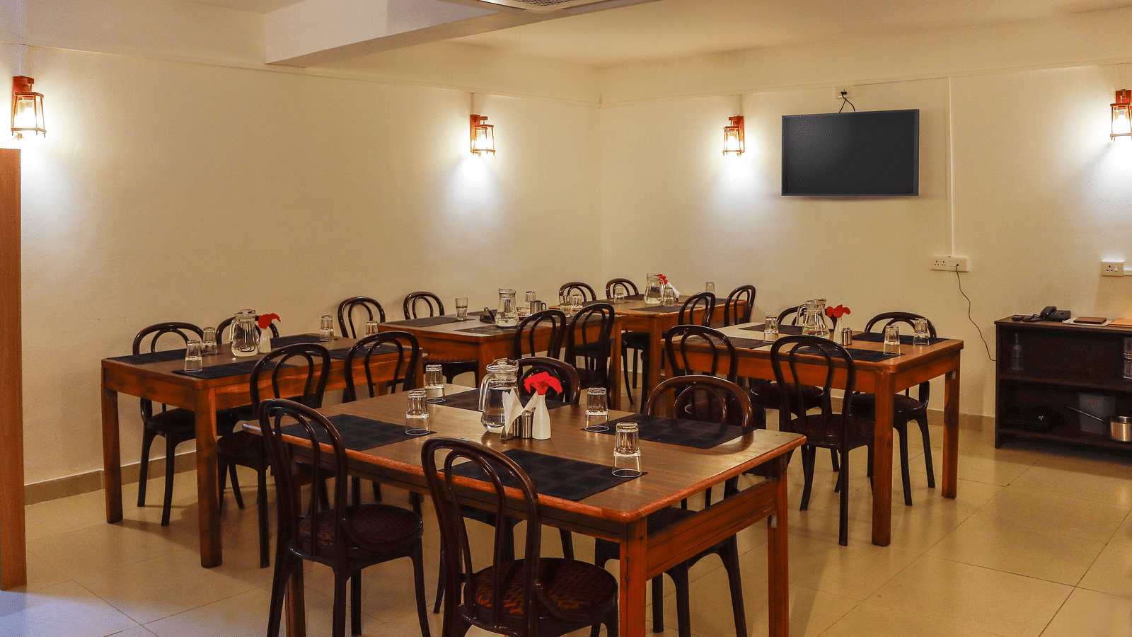 A dining setting of a restaurant at Hotel Vinayaga, Tiruppur.