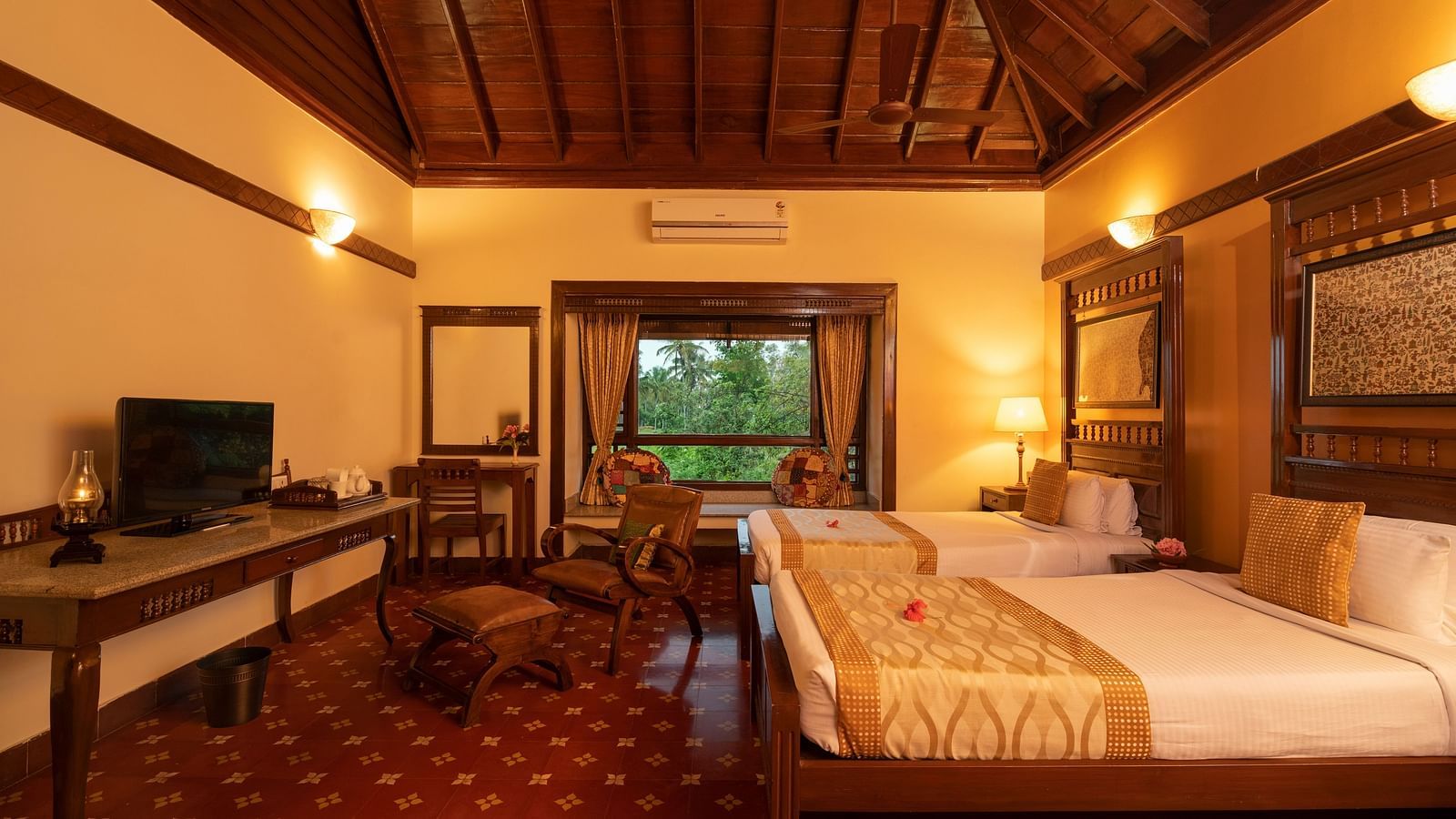 image of a twin bedroom of the heritage premium cottage featuring a brightly lit room at hoysala village resort