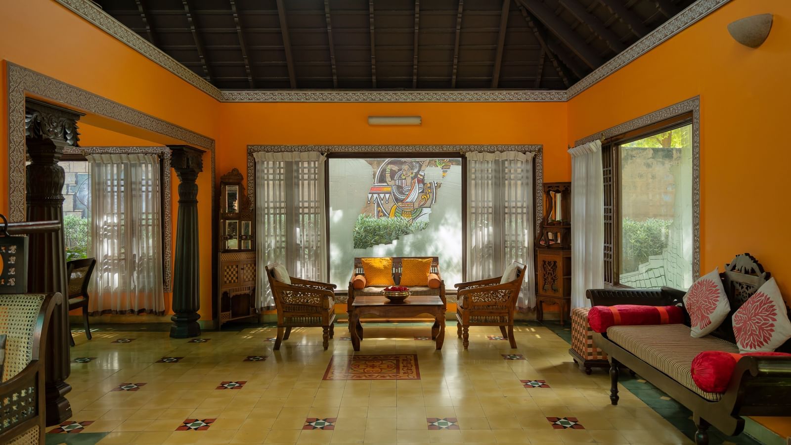 An overview of the lobby of Hoysala Village Resort, Hassan, with seating arrangements in view.