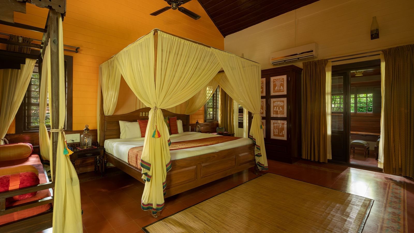 An image of a poster twin bed in a wooden furnished room - Hoysala Village Resort, Hassan