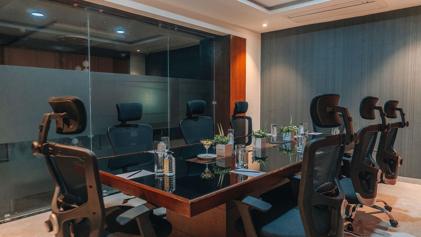 a Board room with a rectangular table surrounded by chairs - Jardin Hotels, Indore