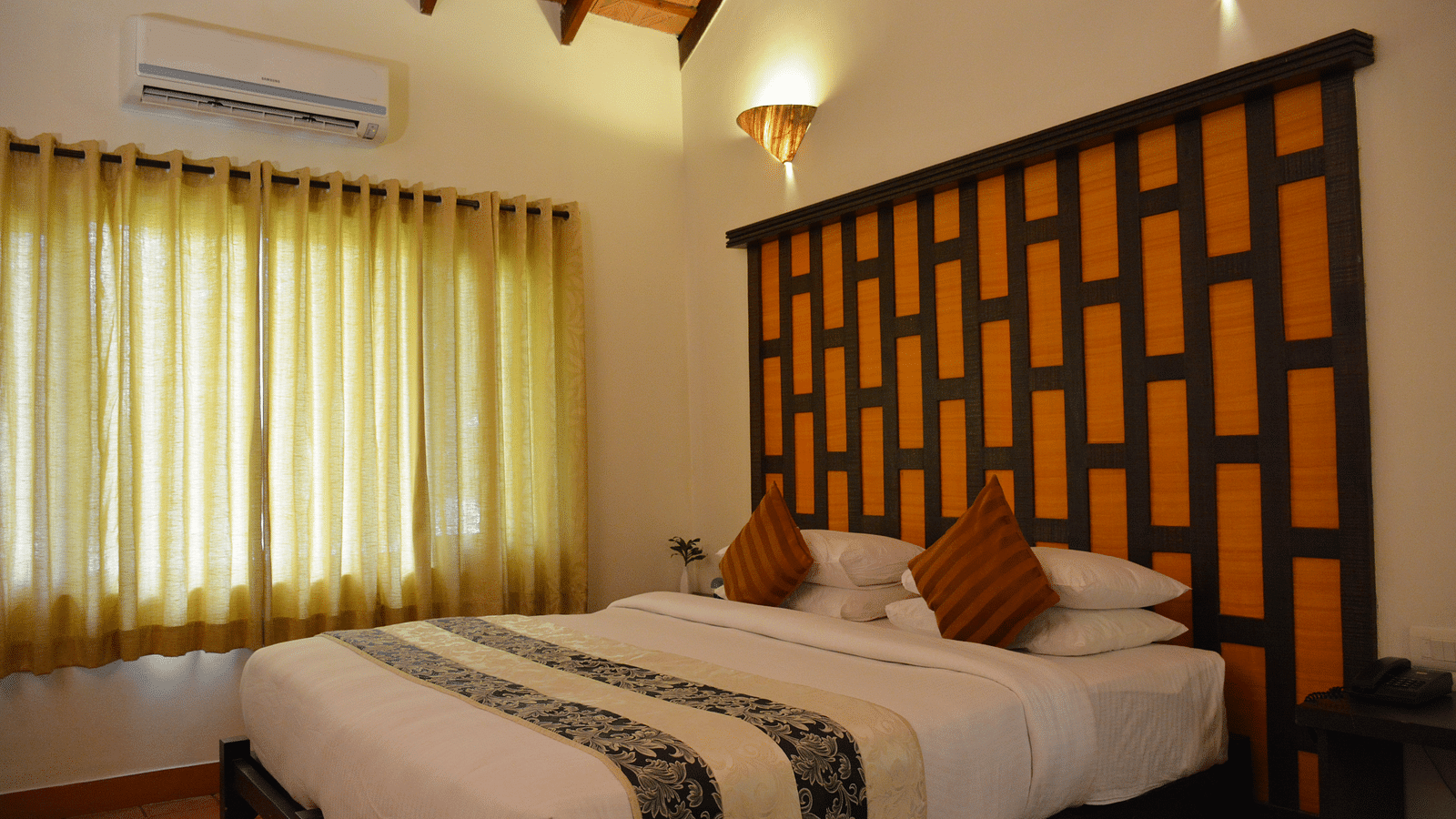 view of a bedroom with a large bed and windows covered with curtains - Kadkani River Resort, Coorg