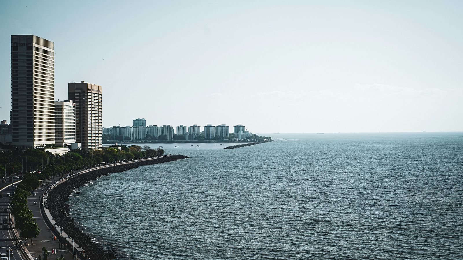 An image of a sea coast with buildings on one side
