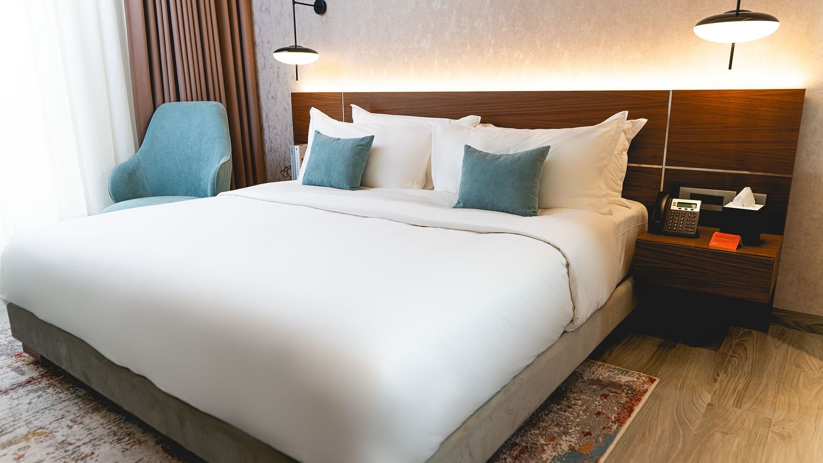 An overview of a bedroom with plush bedding inside two bedroom suite - kertel suites, kinshasa