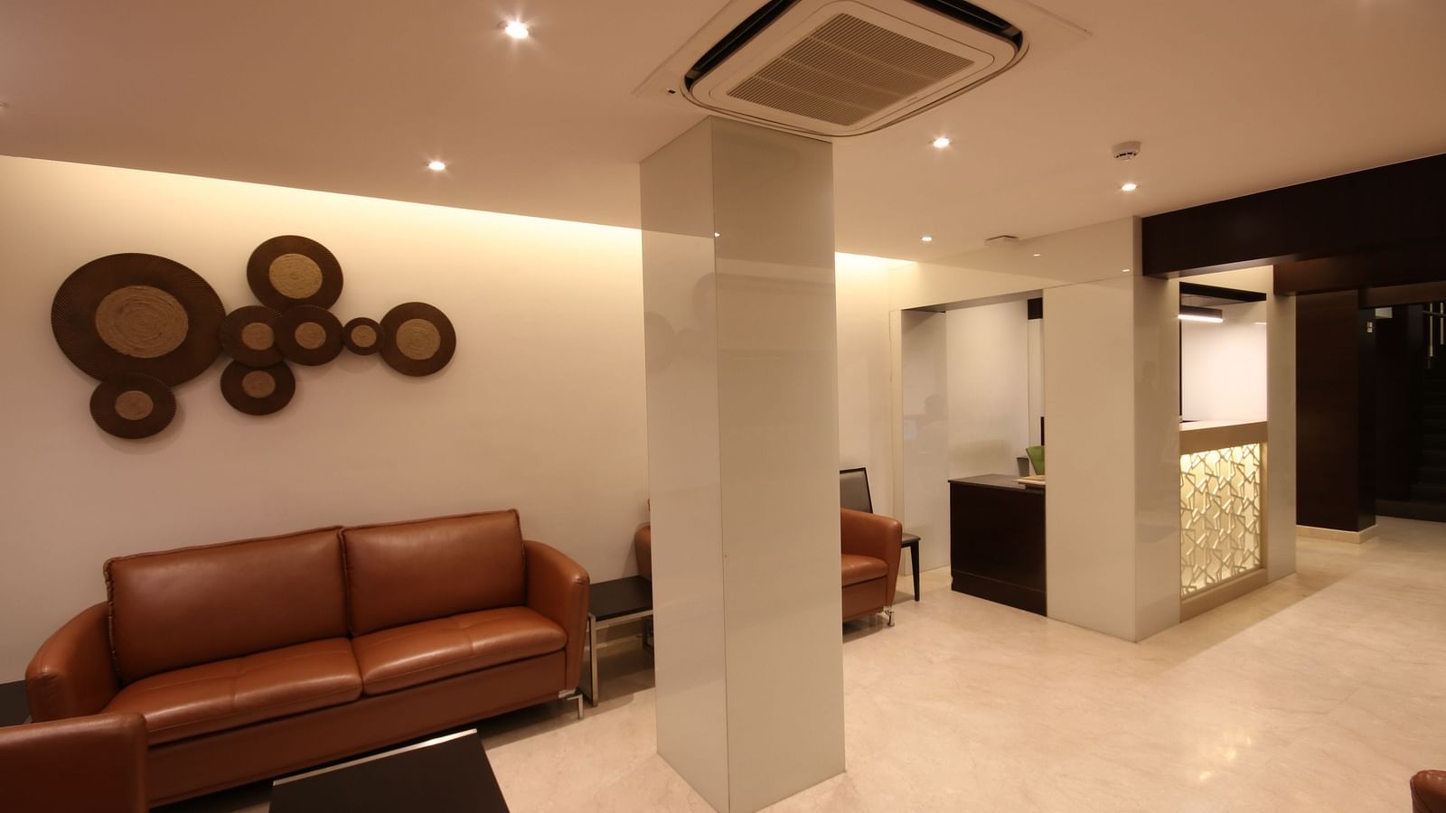 view of the lobby area with comfortable chairs and warm lights at Khanna Fiesta, Vellore