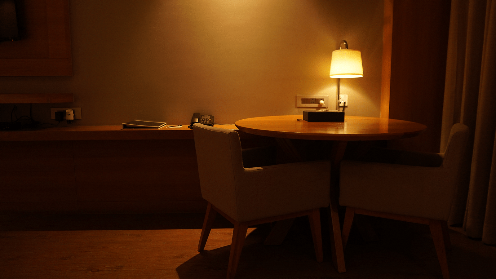 Warm lighting with a wooden table and two chairs placed