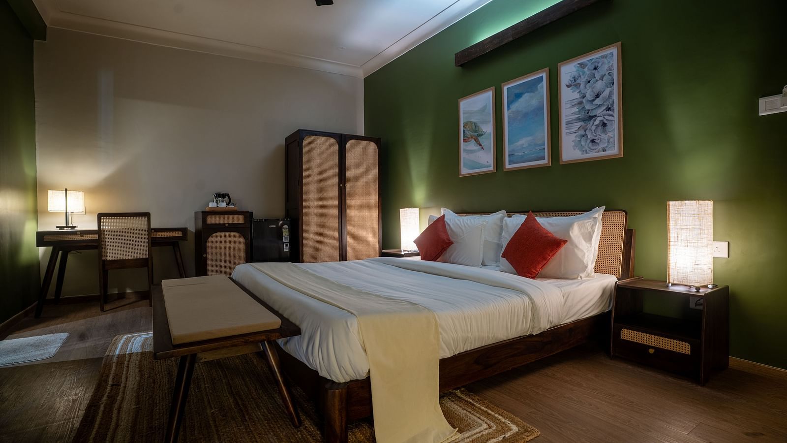Well-lit bedroom with green accent wall, cosy furnishings, and twin beds at Kssemya.