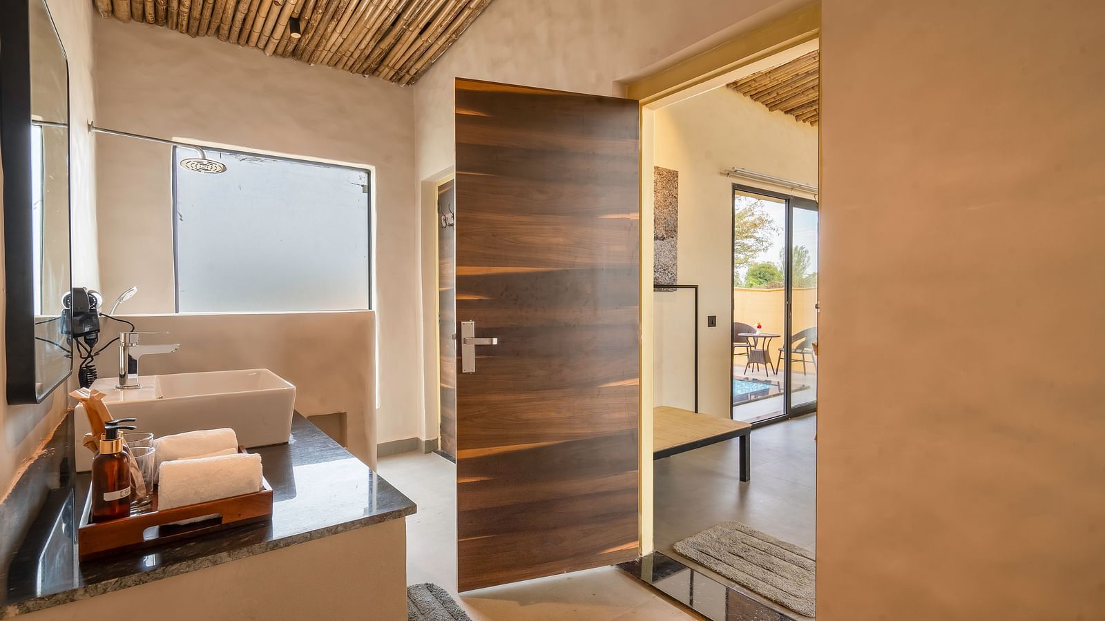 An image of a washroom featuring a sink and faucet, a tray where towels and body wash are kept - Kurja Jawai