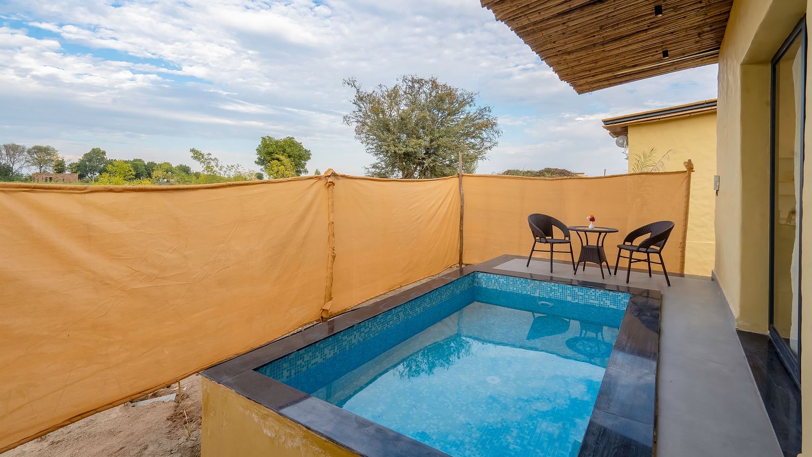 An image of a Plunge Pool of Jungle Cottage and a seating area behind it at Kurja Jawai