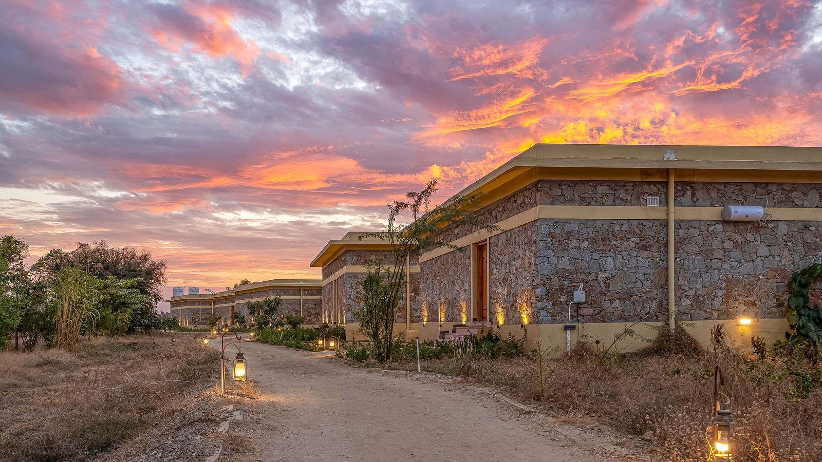 An image of lit pathway leading to the cottages of Kurja Jawai