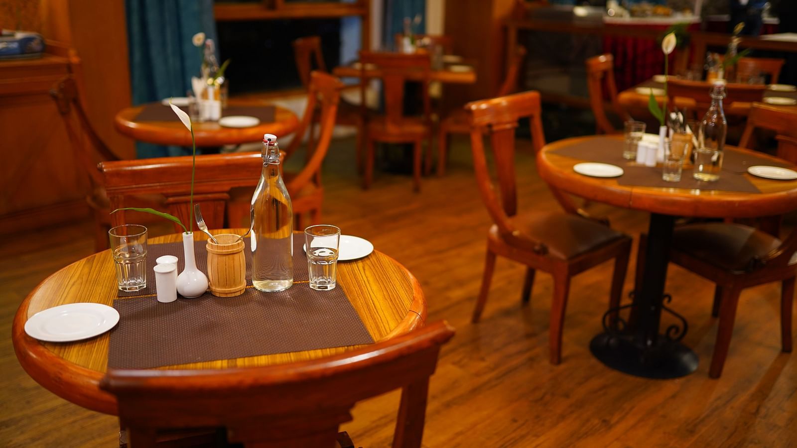 a view of dining table featuring clear plates and water bottles at La Montana By TGI, Ooty
