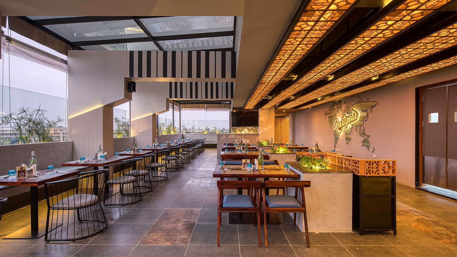 Interior of Roastopolis Restaurant at Le Foliage by TGI, Bangalore with tables and chairs