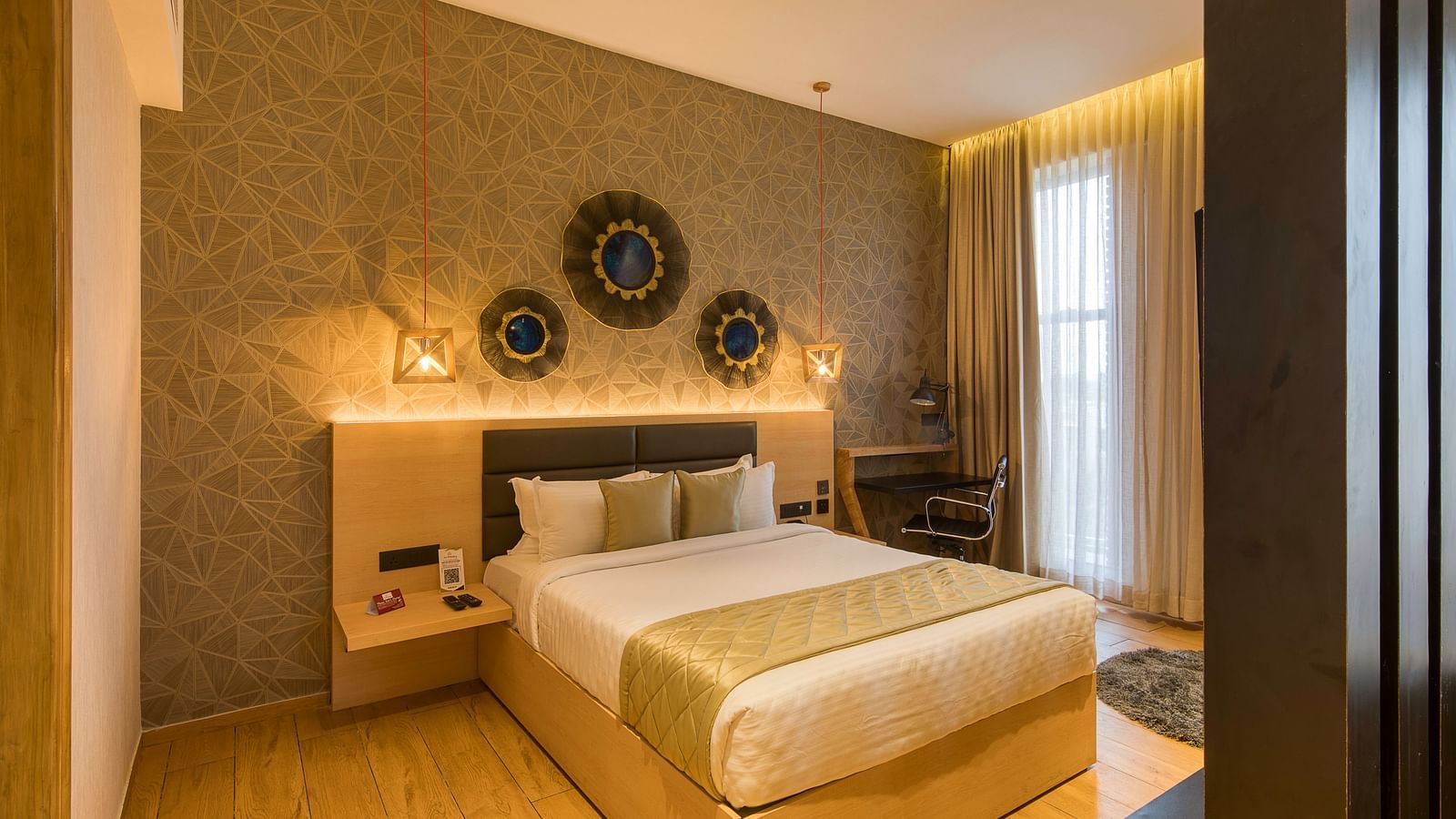 A double bed with golden bedsheets at Sumo Suite at Le Foliage by TGI, Bangalore